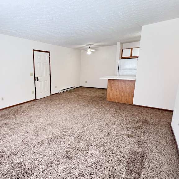 a room with a carpeted floor and a door.
