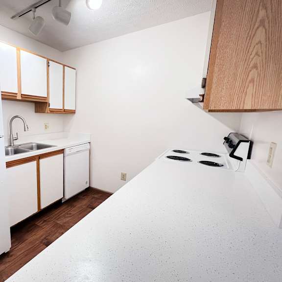 a white refrigerator is in a kitchen with wooden cabinets.