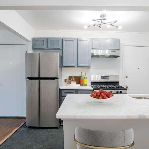 A kitchen with a refrigerator, stove, and sink. at Ann Street Lofts, Mobile, 36604