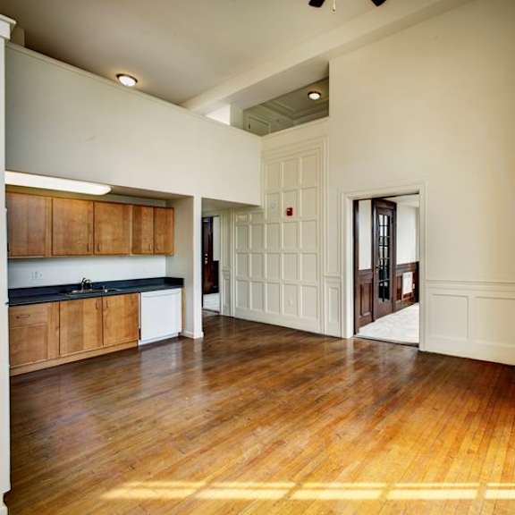 a room with wooden floors and white walls.