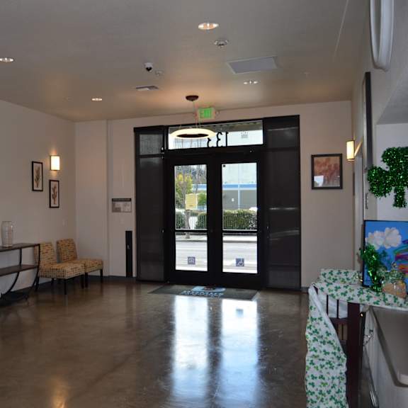 a waiting room with chairs and pictures on the wall.