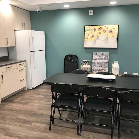 a kitchen with a dining table and chairs.