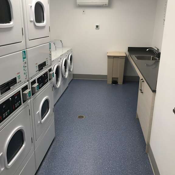 a row of washing machines in a laundry room.