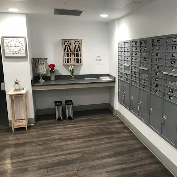 a row of mailboxes are lined up against a wall.