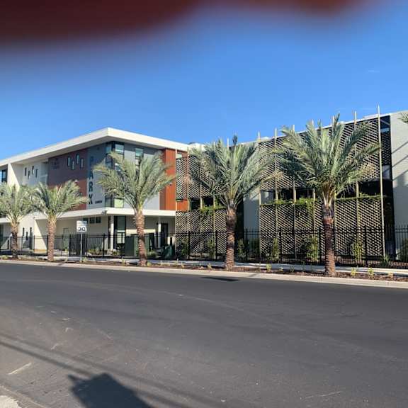 a building with palm trees in front of it.