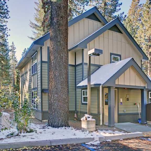 a house with a grey roof and a brown garage door.
