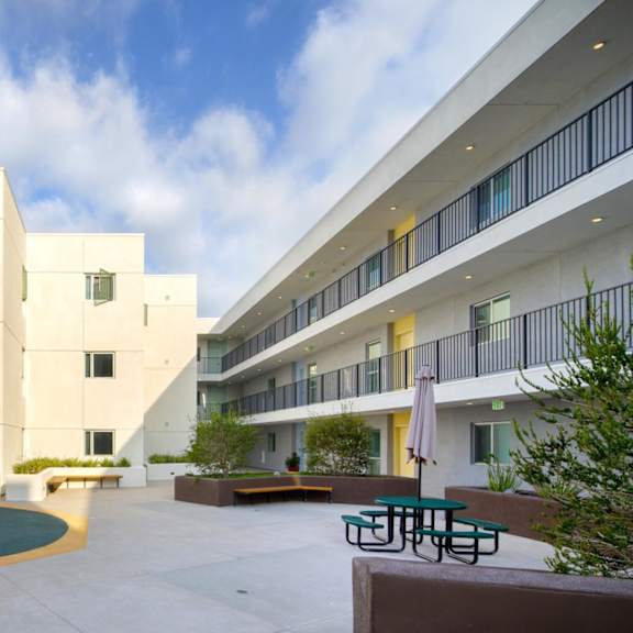 a modern building with a pool in the courtyard.