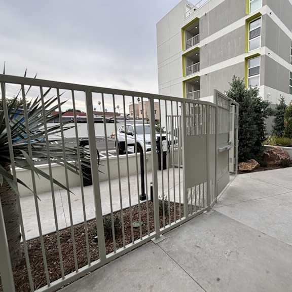 a metal gate blocks the entrance to a parking lot.