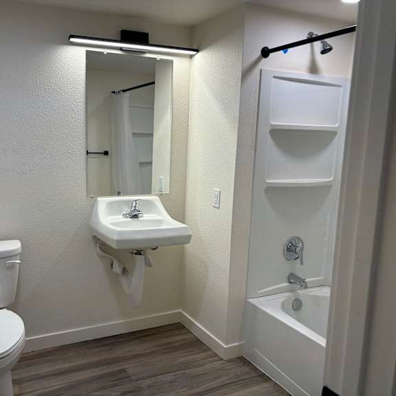 a white toilet is next to a sink in a small bathroom.