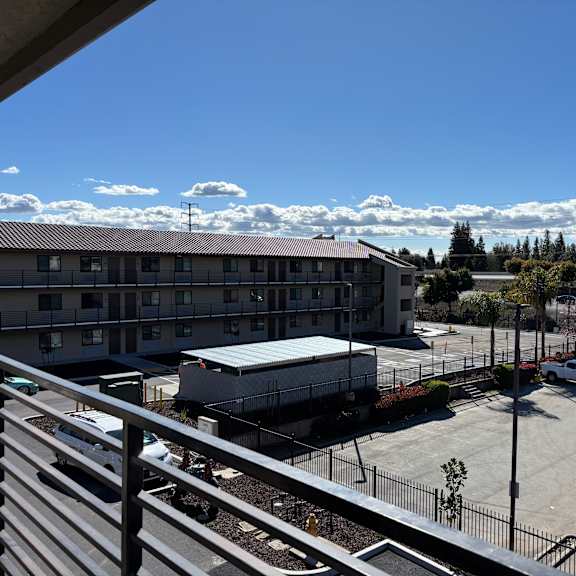 a parking lot with a building in the background.