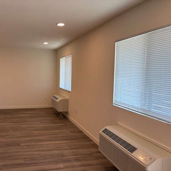a room with a window and a heater on the floor.