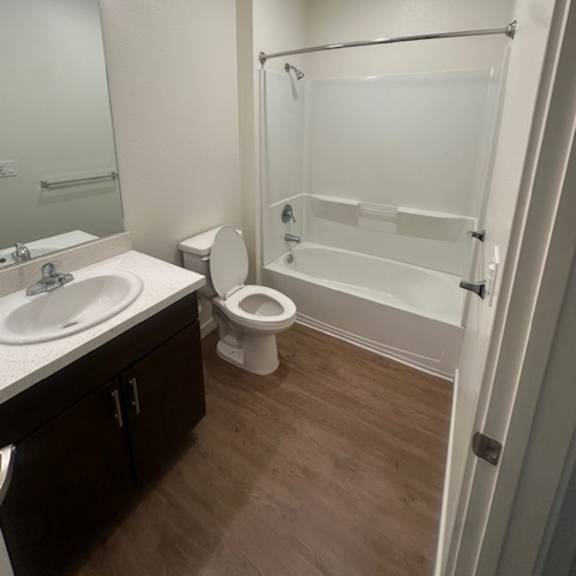 a white toilet is in a small bathroom with a walk-in shower.