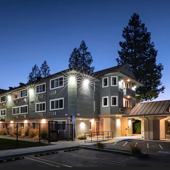a large, modern building with a glowing exterior at night.