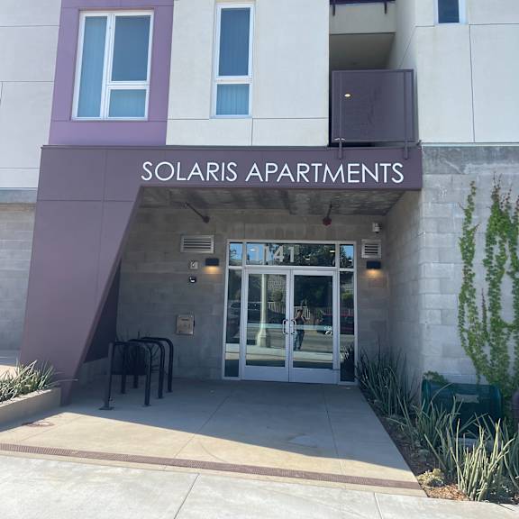 a building with the words solaris apartments on the side.