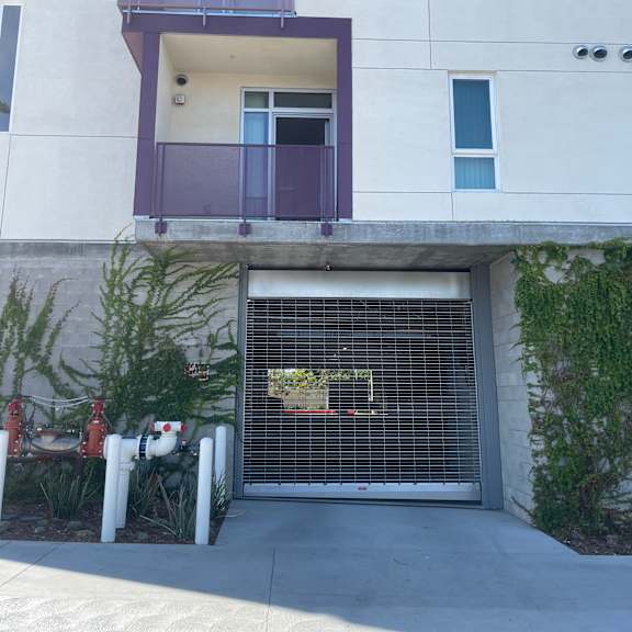 a white building with a purple door and windows.