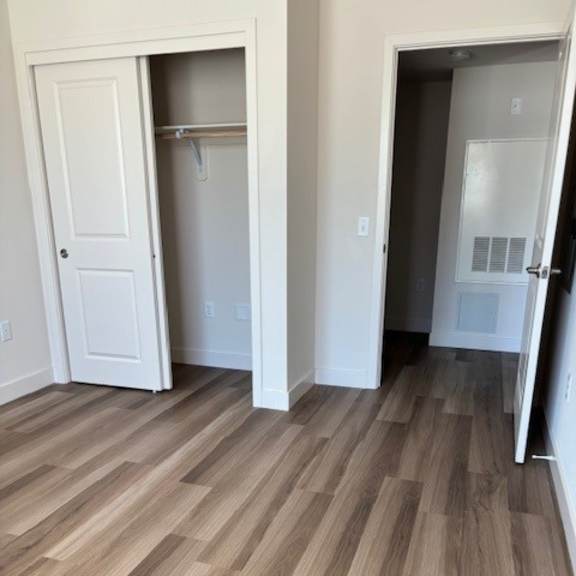 a room with a white door and a white closet with a white door.
