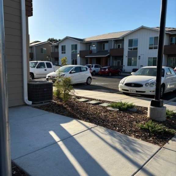 a white car is parked in front of a building.