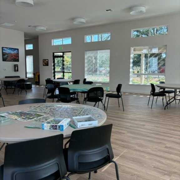 a room with tables and chairs and a map on the table.