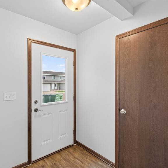 a room with a white door and a brown door.