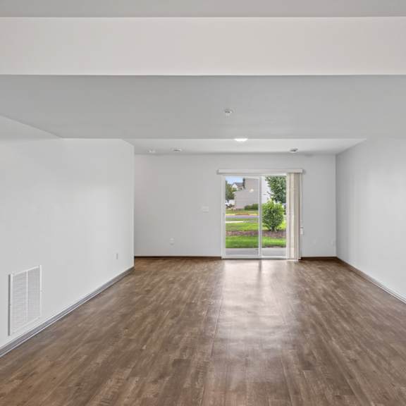 a room with wooden floors and white walls.