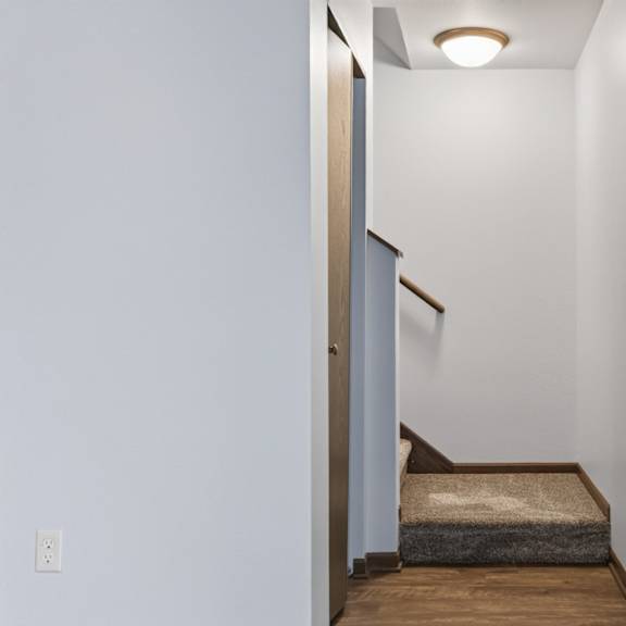 a small room with a bed and a light on the ceiling.