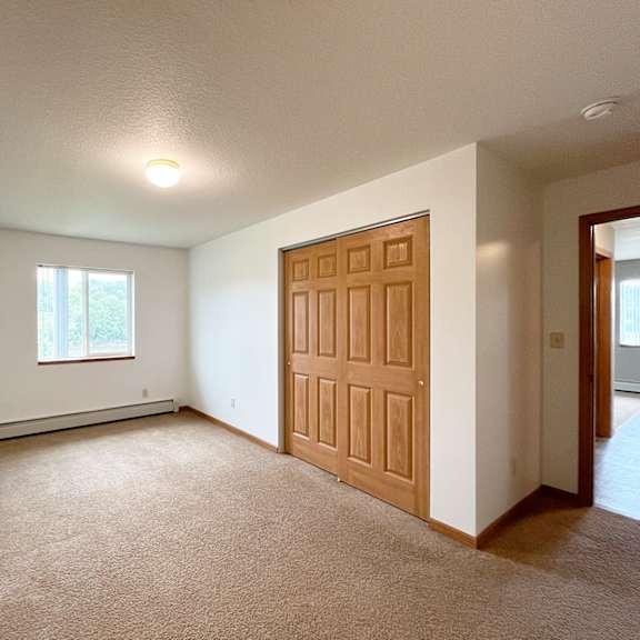 a room with a brown door and a window.