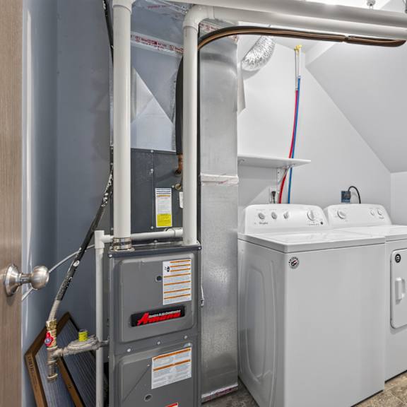 a washing machine and dryer in a small laundry room.