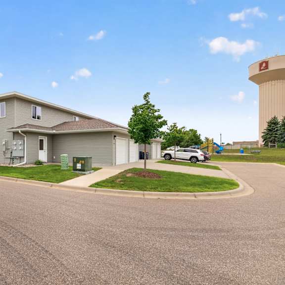 a residential area with a house, a car, and a water tower.