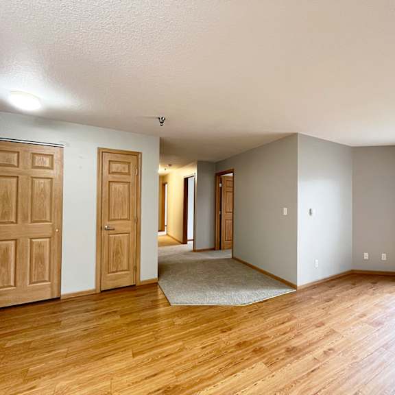a room with wooden floors and white walls.