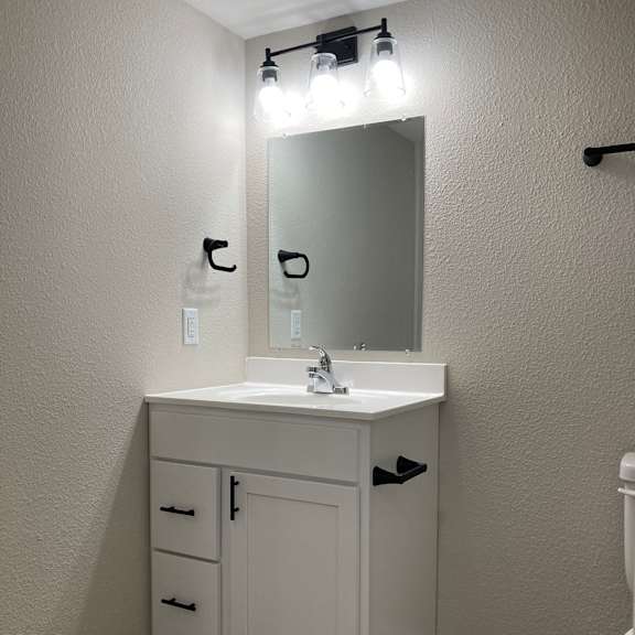 a bathroom with a sink and a mirror