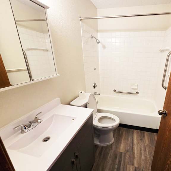 a white sink and toilet in a small bathroom.