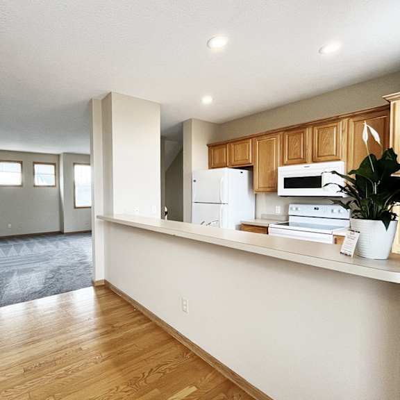 a kitchen with wooden cabinets and a white fridge.
