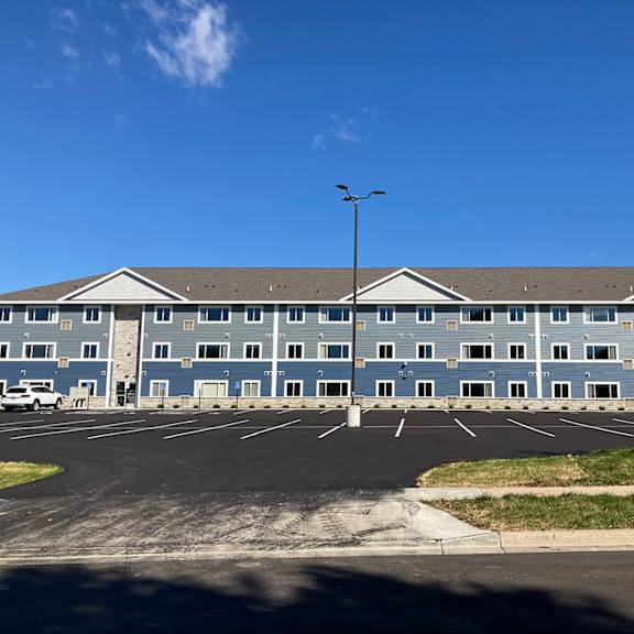 a large building with a parking lot in front of it.