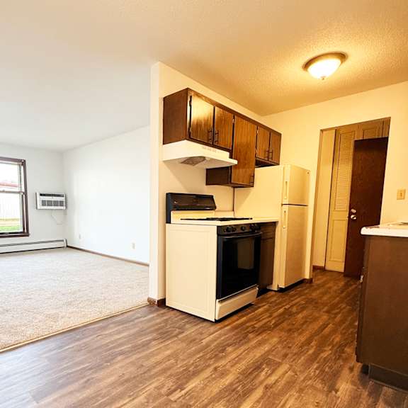 a kitchen with a white oven and wooden cabinets.