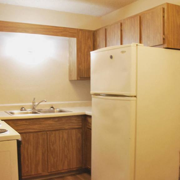 a kitchen with a refrigerator and a sink