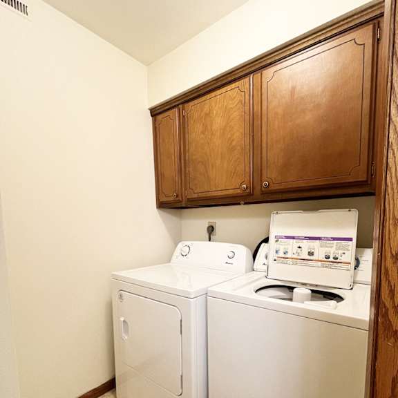 a small laundry room with a washer and dryer.