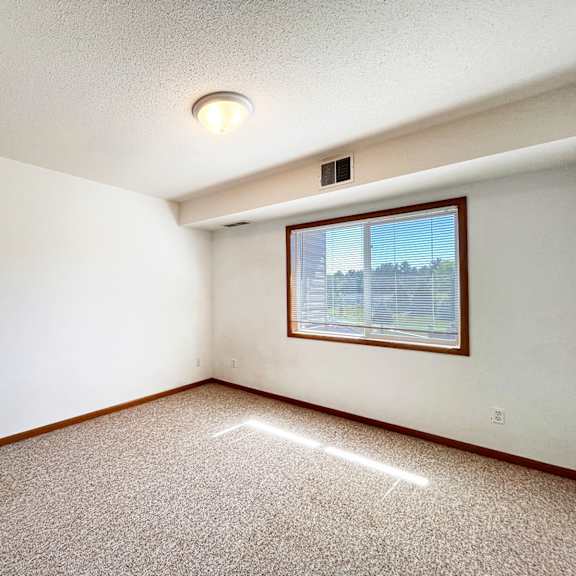 a room with a window and a ceiling light.