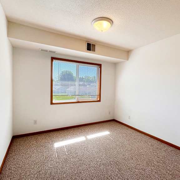 a room with a window and a ceiling light.