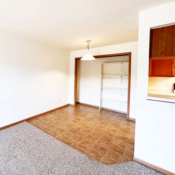 a room with a carpeted floor and a wooden floor.