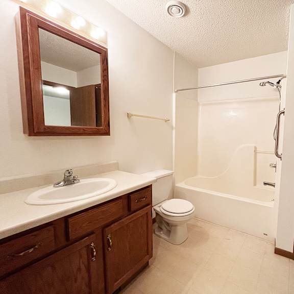 a bathroom with a sink, toilet, and bathtub.