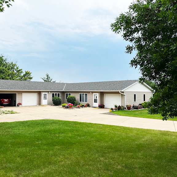 a house with a grey roof and a garage door.