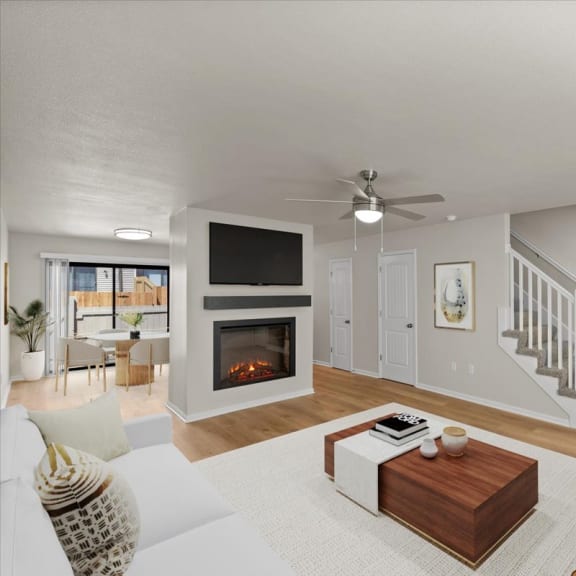 Thumbnail 2 of 10 a living room with a couch and a fireplace