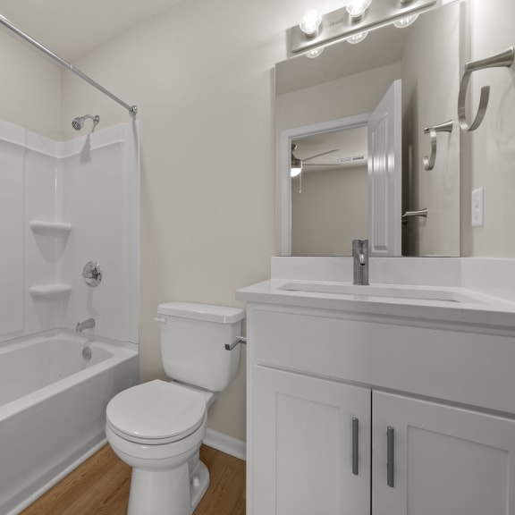 Thumbnail 8 of 13 a bathroom with a shower toilet and sink and a mirror
