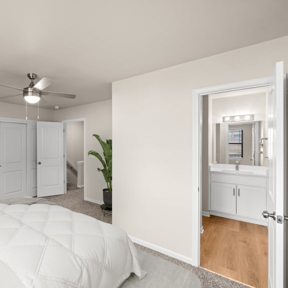 Thumbnail 9 of 13 a bedroom with a white bed and a ceiling fan