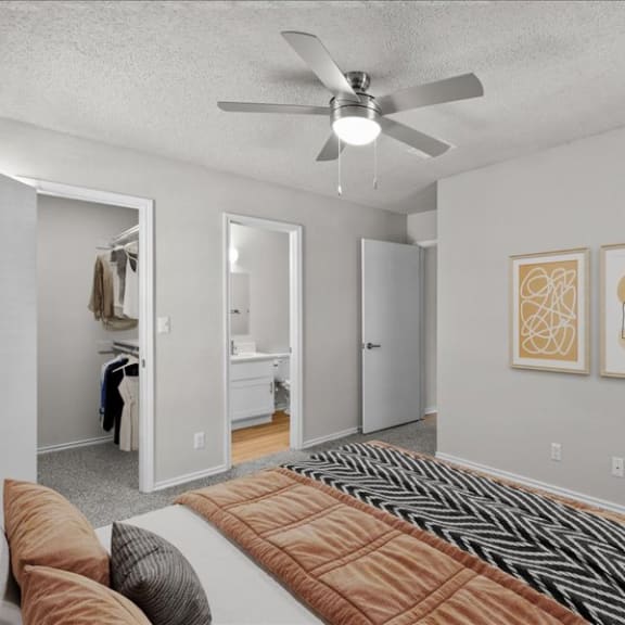 Thumbnail 7 of 13 a bedroom with a bed and a ceiling fan
