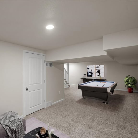 Thumbnail 11 of 13 a living room with a pool table and a couch