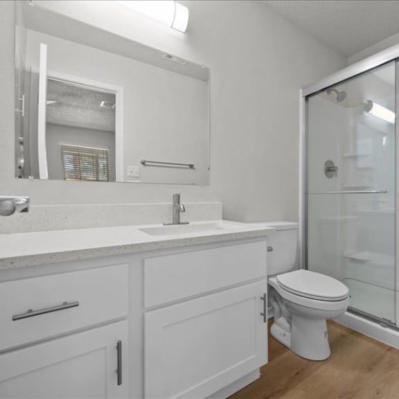 Thumbnail 11 of 13 a bathroom with a sink toilet and a shower