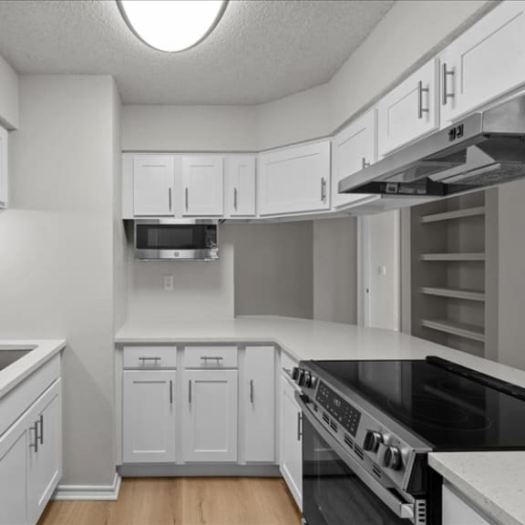 Thumbnail 9 of 13 an empty kitchen with white cabinets and a sink