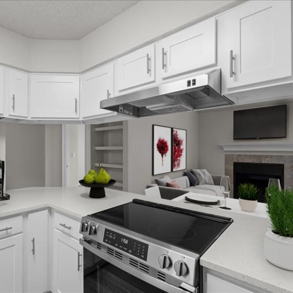 Thumbnail 5 of 13 a white kitchen with a stove and a microwave