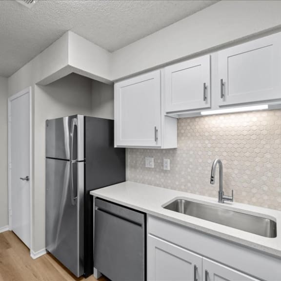 Thumbnail 13 of 13 a kitchen with white cabinets and a stainless steel refrigerator